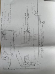 Hand-drawn mechanical engineering schematic on paper.